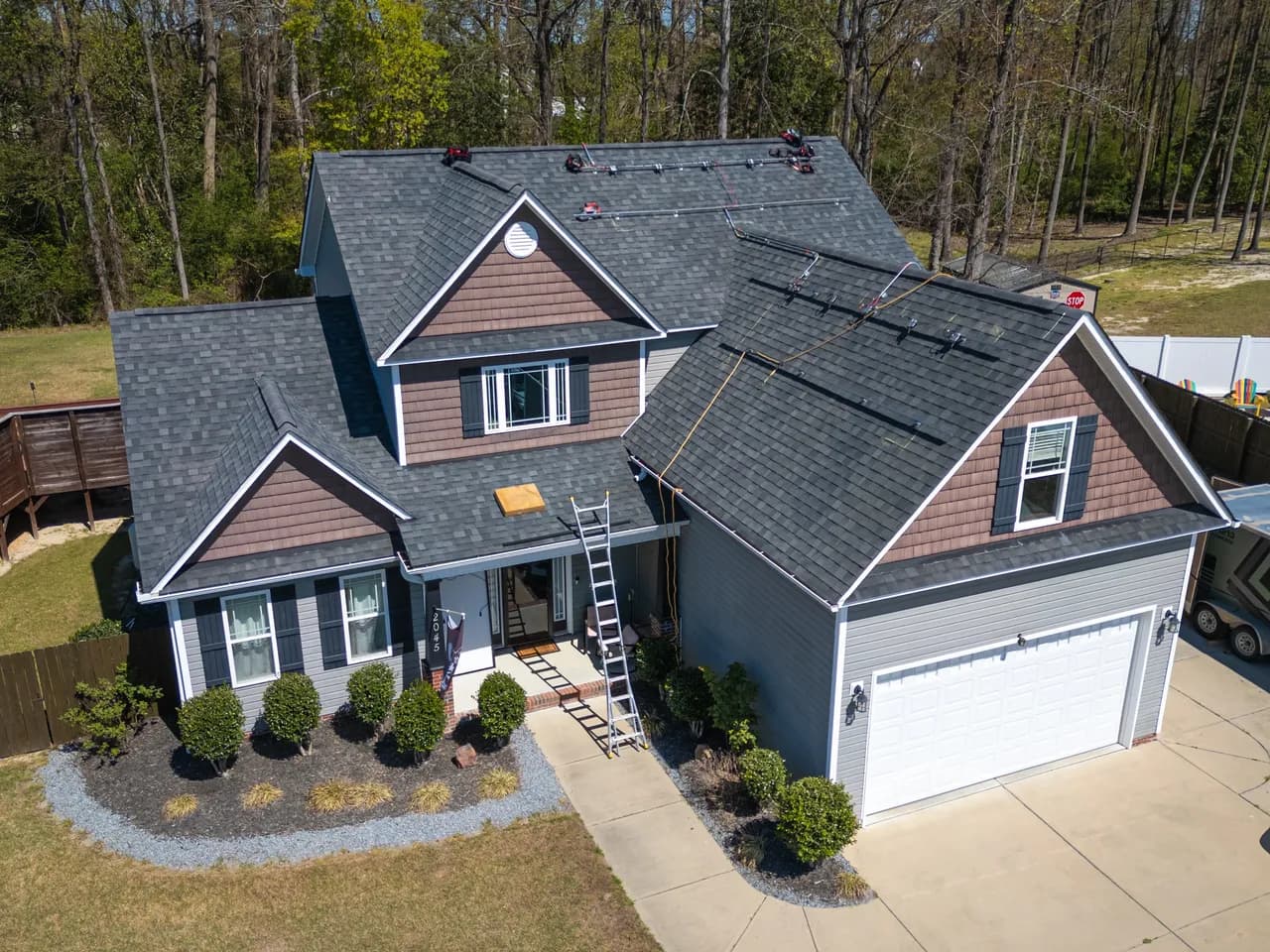 Aerial view of a completed roof replacement on a two-story home