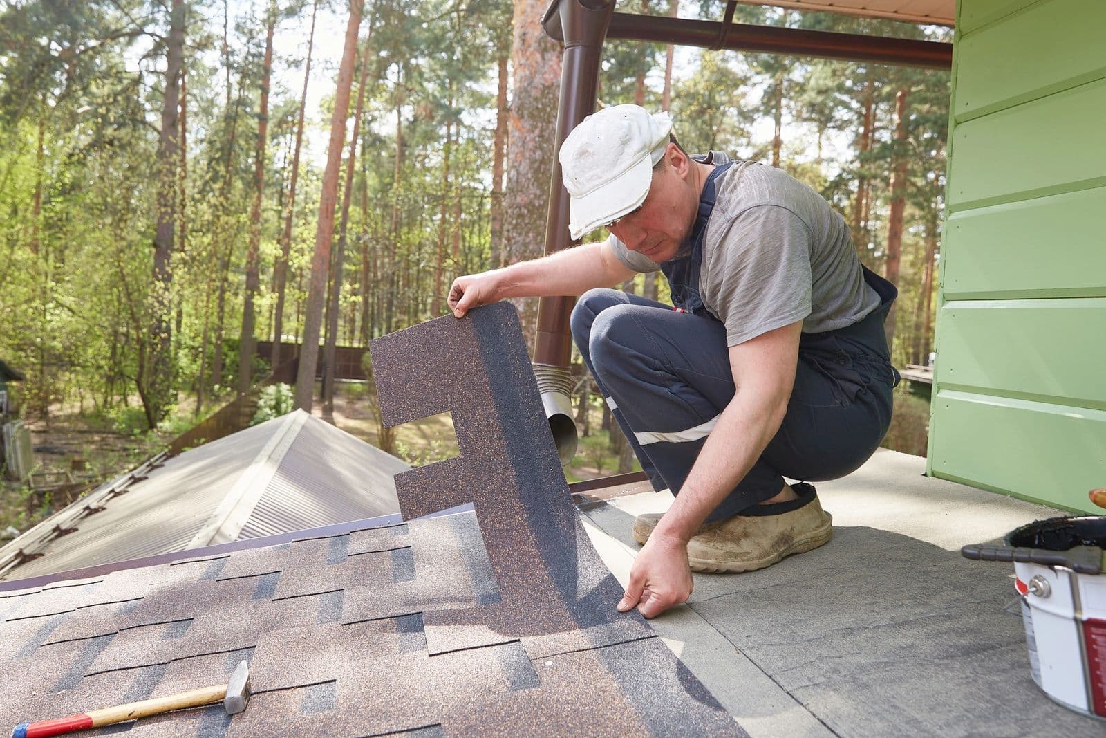 Roofer repairing flashing on a residential roof in Central Pennsylvania